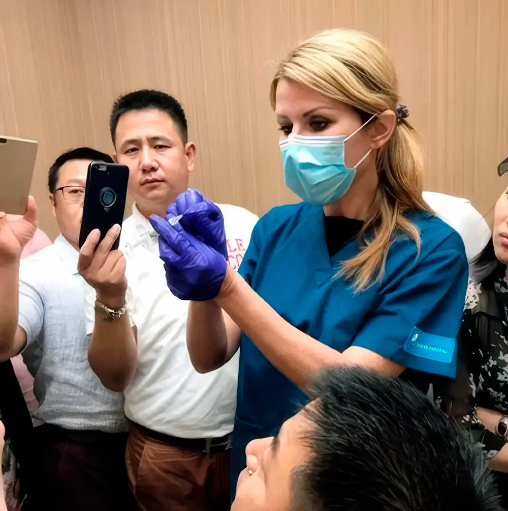 Portrait of Dr Ivona Igerc (Dr. Ivy) London performing a treatment